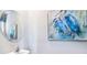 Small bathroom with pedestal sink, framed art, and a round mirror at 32619 Turtle Grace Loop, Wesley Chapel, FL 33545