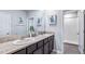 Double vanity bathroom with granite countertop and shower at 32619 Turtle Grace Loop, Wesley Chapel, FL 33545
