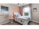 Cozy bedroom with a unique wall accent and natural light at 32619 Turtle Grace Loop, Wesley Chapel, FL 33545
