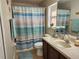 Clean bathroom with shower/tub combo and striped shower curtain at 3604 Harvest Orchard Dr, Plant City, FL 33567