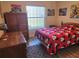 Bedroom with Mickey Mouse bedding, wooden wardrobe, and flooring at 3604 Harvest Orchard Dr, Plant City, FL 33567