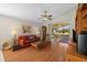 Living room with hardwood floors, a comfy couch, and access to a screened porch at 4275 Caskie Pl, Brooksville, FL 34604