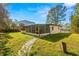 Backyard view with screened patio and grassy area at 4704 W Chapin Ave, Tampa, FL 33611