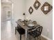 Modern dining area with metal table and woven chairs near entry at 477 Mangrove Shade Cir, Apollo Beach, FL 33572