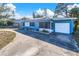 House front with driveway and attached garage at 4825 Dr Martin Luther King Jr S St, St Petersburg, FL 33705