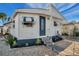 Charming mobile home with striped awnings, landscaping, and a paved driveway at 4851 W Gandy Blvd # B6 L3, Tampa, FL 33611