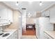 Kitchen with white cabinets, stove, refrigerator, and dining area view at 4851 W Gandy Blvd # B6 L3, Tampa, FL 33611
