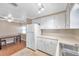 White kitchen with stainless steel sink and refrigerator at 4851 W Gandy Blvd # B6 L3, Tampa, FL 33611