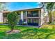 Condo building with screened patio and landscaping at 511 Duxbury Ct # C, Safety Harbor, FL 34695