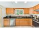 Well-equipped kitchen with wood cabinets and granite countertops at 511 Duxbury Ct # C, Safety Harbor, FL 34695