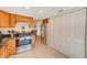 Kitchen features wood cabinets, granite countertops, and stainless steel appliances at 511 Duxbury Ct # C, Safety Harbor, FL 34695