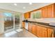 Kitchen offers wood cabinets, granite counters, and a view to the patio at 511 Duxbury Ct # C, Safety Harbor, FL 34695