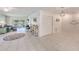 Open living room with tile floors, comfortable seating, and access to balcony at 511 Duxbury Ct # C, Safety Harbor, FL 34695