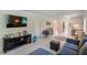Living room with sectional sofa, media console, and view to kitchen at 511 Duxbury Ct # C, Safety Harbor, FL 34695
