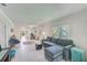 Bright living room features tile floors and a comfy sectional sofa, offering a relaxing space at 511 Duxbury Ct # C, Safety Harbor, FL 34695