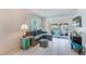 Living room with a comfy sectional sofa, a large TV, and access to a patio at 511 Duxbury Ct # C, Safety Harbor, FL 34695