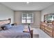 Bedroom with wood bed frame and large window at 5221 Hillside Meadow Pl, Tampa, FL 33610