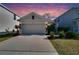 One story home with gray siding, two car garage, and landscaping at 5221 Hillside Meadow Pl, Tampa, FL 33610