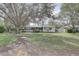 Front yard view of a single story home with a large tree at 6056 2Nd N Ave, St Petersburg, FL 33710