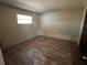 Simple bedroom with a window and wood-look floors at 6307 Langston Ave, New Port Richey, FL 34653