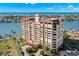 Aerial view of a waterfront condo building with a pool and parking at 700 Island Way # 704, Clearwater Beach, FL 33767