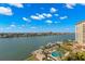 Aerial view showcasing a community pool, waterway, and waterfront homes at 700 Island Way # 704, Clearwater Beach, FL 33767