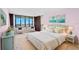 Main bedroom with a king-size bed and water views at 700 Island Way # 704, Clearwater Beach, FL 33767