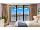 Bedroom with water views and sliding glass doors to balcony at 700 Island Way # 704, Clearwater Beach, FL 33767