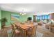 Bright dining room with a wood table and wicker chairs at 700 Island Way # 704, Clearwater Beach, FL 33767