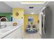 Kitchen with white cabinets, stainless steel appliances, and a small dining area at 700 Island Way # 704, Clearwater Beach, FL 33767