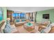 Living room boasts water views and wicker furniture at 700 Island Way # 704, Clearwater Beach, FL 33767