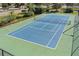 Well-maintained tennis court with green perimeter fencing at 700 Island Way # 704, Clearwater Beach, FL 33767