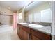 Bathroom boasts a double vanity, tub shower combo, and tile flooring at 7001 Interbay Blvd # 247, Tampa, FL 33616