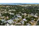 Aerial view showing the neighborhood with houses and lush green trees at 701 25Th Sw St, Largo, FL 33770