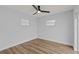 Light grey bedroom with wood-look floors and ceiling fan at 701 25Th Sw St, Largo, FL 33770