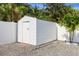 White storage shed with single door in backyard at 701 25Th Sw St, Largo, FL 33770