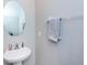 Clean bathroom with pedestal sink and oval mirror at 7014 King Creek Dr, Sun City Center, FL 33573