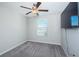 Bedroom with ceiling fan and window with blinds at 7014 King Creek Dr, Sun City Center, FL 33573