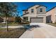 Two-story house with gray siding, two-car garage, and a well-manicured lawn at 7014 King Creek Dr, Sun City Center, FL 33573