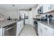 Modern kitchen with white cabinets, granite countertops, and stainless steel appliances at 7014 King Creek Dr, Sun City Center, FL 33573