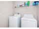 Laundry room with washer, dryer, and overhead shelving at 7014 King Creek Dr, Sun City Center, FL 33573