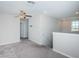 Loft area with grey carpet and ceiling fan at 7014 King Creek Dr, Sun City Center, FL 33573