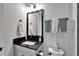 Stylish bathroom with black vanity and fixtures at 9152 Warm Springs Cir, Parrish, FL 34219