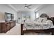 Main bedroom with a king-size bed and large TV at 9152 Warm Springs Cir, Parrish, FL 34219