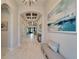 Entryway with a bench, large art piece, and views into the living area at 9152 Warm Springs Cir, Parrish, FL 34219