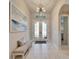 Entryway with double doors, bench, and art at 9152 Warm Springs Cir, Parrish, FL 34219