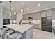 Modern kitchen with large island and quartz countertops at 9152 Warm Springs Cir, Parrish, FL 34219