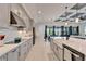 Modern kitchen with gray cabinets, white countertops, and geometric backsplash at 9152 Warm Springs Cir, Parrish, FL 34219