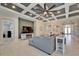 Open concept living area with coffered ceiling and kitchen view at 9152 Warm Springs Cir, Parrish, FL 34219