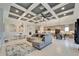 Open concept living area with coffered ceiling and access to backyard at 9152 Warm Springs Cir, Parrish, FL 34219
